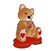 Brown teddy bear with red heart on feet sits on red base, holding red gift box, shown from multiple angles including front, side, and back views.