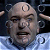 Pixelated close-up of a bald figure with pointed ears, wearing light blue clothing against dark background.