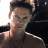 A pixelated image of a person with short dark hair wearing a brown shirt, next to green text reading 'Original Icons .com' on a solid background.