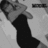 Pixelated grayscale image of a figure in dark clothing holding an object, with partial text visible on the right side.