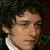 Two side-by-side show a person with curly hair and another in grayscale; below left displays red text on black background