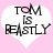 Two identical heart-shaped icons with pink backgrounds and white interiors displaying the text "TOM IS BEASTLY" in black pixelated font.