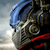 A pixelated close-up of a character wearing a blue helmet and red accents, with a blurred background suggesting motion or speed.