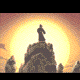 Silhouetted figure atop rocky outcrop against large yellow sun, with four distinct animation states showing changing background elements and character pose.