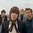 A 48x48 pixel animated contact sheet showing two frames of a group photo with four people and the text "MCFLY" in bold black letters on the right side.