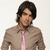 A person with dark hair wearing a beige shirt and pink tie appears in three showing slight head movement against a light background