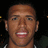 A pixelated image of a person with a dark background, showing three variations of the same face with different mouth positions.