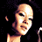 Pixelated image of a person in a black bikini top with visible belly button, dark background, and 'Coolbuddy.com' text on right side.