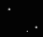 Black background with scattered white dots and four distinct X-shaped light patterns in various states of brightness and size.