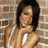 A pixelated image shows a person with dark hair against a brick wall, next to yellow text reading 'Under My Umbrella' on a black background.