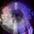 Pixelated image of a light-colored animal with dark eyes and a rounded nose, set against a dark background with blue and purple hues.