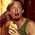 A pixelated contact sheet showing two frames of an animated icon featuring a character with long brown hair in a green tank top holding a golden object, next to green text reading "Original Icons .com" on a dark background.