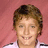 Pixelated image of a person with short brown hair smiling, set against pink and gray background with text "I LOVE my boyfriend" in black font.