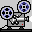 Two pixel-art film projectors on a gray background, each with blue-and-black reels and red indicator lights.