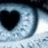 Pixelated eye with black heart-shaped pupils, white text reading 'Love Was Made For U & Me' and '(333)' on a blue-gray background.