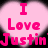 Pixelated pink text on a light pink gradient background with black outer edges, reading "I Love Justin" in three lines.