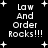 Black background with white pixelated text reading "Law And Order Rocks!!!" surrounded by small plus signs and star shapes.