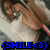 Pixelated image of a person with brown hair wearing glasses and a white top, holding an object near their face, with blue text reading "SMILE<3" at the bottom.