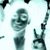 Pixelated image of a figure holding an object with arms raised, surrounded by abstract shapes on white background.