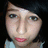 Pixelated close-up of a person's face with light skin, dark hair, and pink lips against a black background.