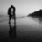 Black-and-white pixelated image of a figure standing on a reflective surface with a blurred background, displaying text overlay.