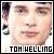 Pixelated static buddy icon featuring a close-up of a person's face with text "TOM HELLING" at the bottom, set against a white background with partial dark and light side elements.