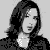 Black-and-white pixelated image of a woman with long dark hair in three above a black banner with repeated 'Michelle' text and small plus symbols