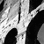 Pixelated grayscale image showing abstract white and black shapes with diagonal lines and scattered dots on a gray background.