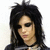 Pixelated portrait of a person with long dark hair, wearing a black choker necklace and dark clothing against a light background.