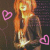 Pixelated static image of a stylized figure with orange hair and pink heart symbols on dark background.