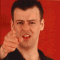 A person with short dark hair points at the viewer against a red background, then shifts to a close-up of their face and hand gesture.