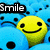 Animated icon shows a yellow smiley face with black eyes and mouth, surrounded by blue cartoon characters on the left; orange circular background appears on the right.