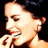 Static 48x48 pixel icon showing a close-up of a person's face with closed eyes and a slight smile, holding a microphone against a dark background.