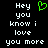Pixelated text 'Hey you know i love you more' in white on black background with a green heart symbol above the right-side text block.