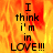 A pixelated text-based animation with fiery orange-yellow background and black text reading "I think i'm in LOVE!!!" displayed