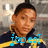 A person in a dark blue jacket with yellow stripes stands against a blurred background, with pixelated text overlays changing across frames.