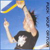 A person with tattoos on arms and neck wears a black t-shirt with white graphic, points index finger up while holding yellow-and-blue object above head against blue sky background.