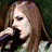 Four pixelated show a woman with long hair in different poses: singing into microphone, neutral expression, dark clothing, and signature on light background
