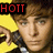 Pixelated image of a person with brown hair and light skin, wearing dark clothing with a white collar, extending their right hand toward the viewer against a yellow background.