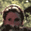 A pixelated animated sequence shows a person with dark hair in a light-colored headband against a blurred green background, transitioning through multiple facial expressions.