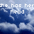 Pixelated text reads 'she has her head in the clouds!' over a blue sky with white clouds.