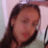 A pixelated close-up of a person with long dark hair, closed eyes, and red lips against a light background.