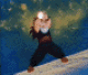 Pixelated character in martial arts stance with hands raised, emitting bright light from palms against blue-green background.