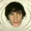 12 showing a person with dark brown hair and light skin against a white background with concentric circles, displaying changing facial expressions