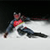Pixelated static image of a figure in athletic gear performing a slalom skiing motion on snow with blurred background.