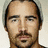 Pixelated image of a man with dark hair and mustache, overlaid with text reading "why is colin ferrall so hot???" and "i guess the world will never know..." in blocky font.