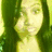 A pixelated image of a person with long dark hair, wearing a white top and earrings, in two side-by-side views showing slight facial expression differences.