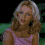 A woman with blonde hair in a pink sleeveless top appears across three showing sequential facial expressions against a dark green background