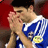 Static 48x48 pixel icon showing a cartoon-style soccer player in blue and white uniform with yellow emblem, hands clasped near face, against red background.