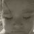 A grayscale animated sequence showing a child's face with closed eyes, transitioning from a neutral expression to a slight smile.